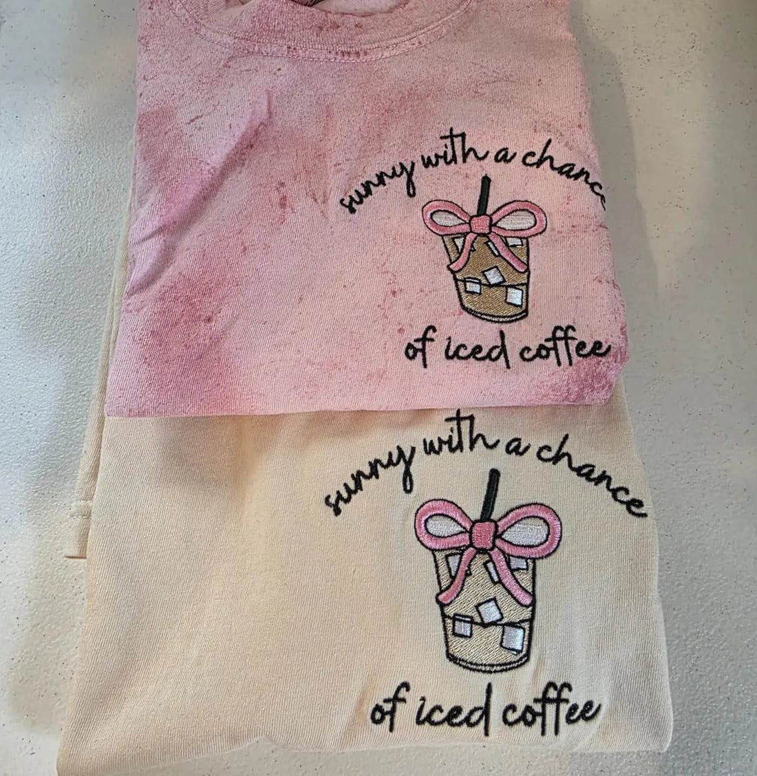 Two pink and beige towels with coffee-themed designs and text on a light background.but-first-coffee-shirt
