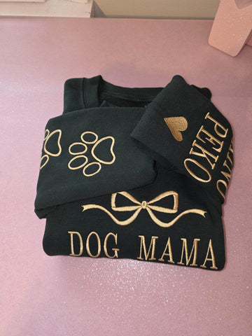 Black sweatshirt with gold text and designs on a pink surface.custom-couple-shirt