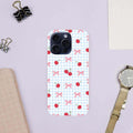 Phone case with cherry and bow pattern on a light purple background.coquette-phone-case