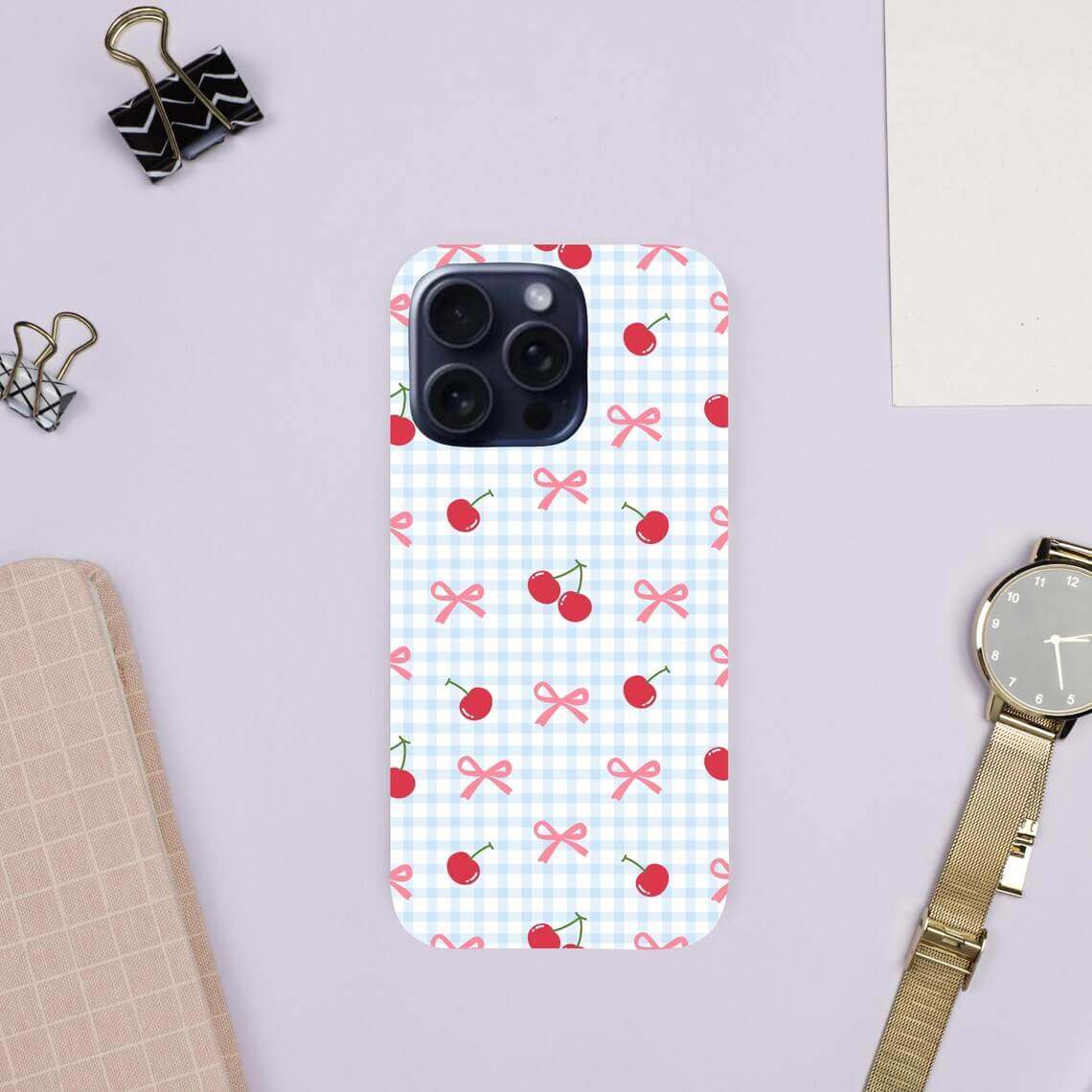 Phone case with cherry and bow pattern on a light purple background.coquette-phone-case