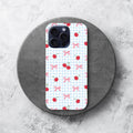 Phone case with cherry and bow pattern on a white background.coquette-phone-case