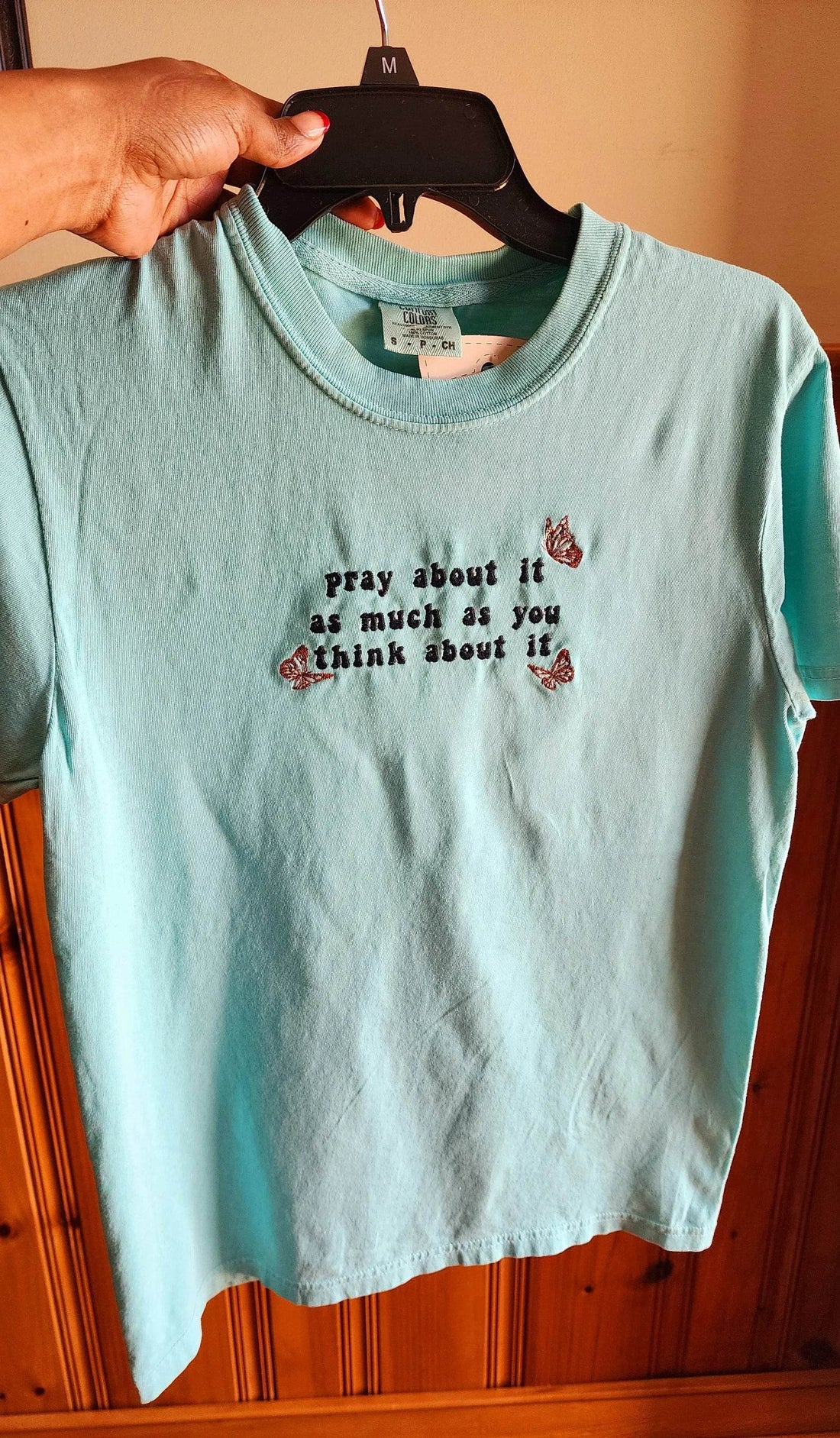 A blue t-shirt with the text 'pray about it as much as you think about it' printed on the front. pray-t-shirt