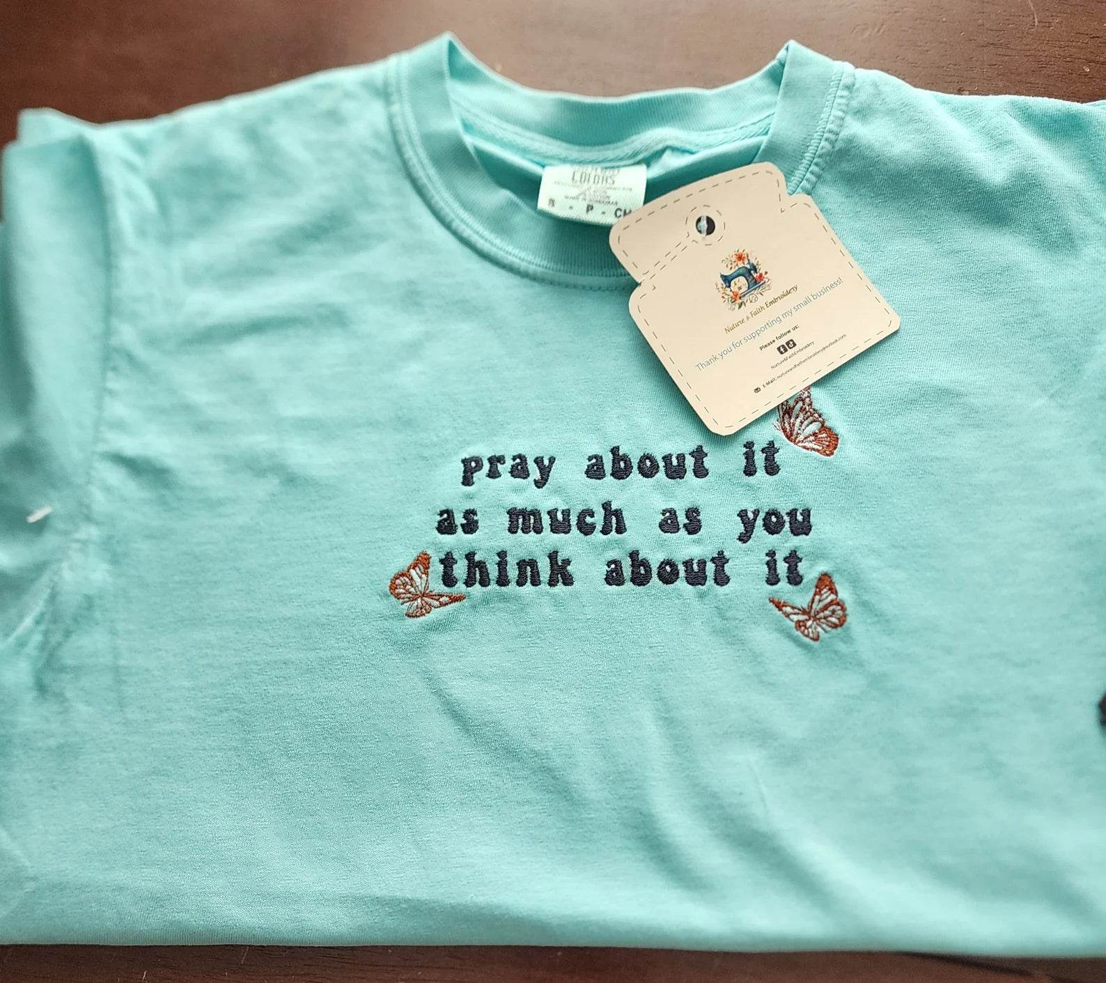 A blue t-shirt with the text 'pray about it as much as you think about it' printed on the front. pray-t-shirt