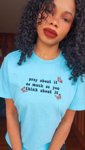 A blue t-shirt with the text 'pray about it as much as you think about it' printed on the front. pray-t-shirt