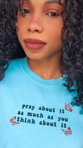 A blue t-shirt with the text 'pray about it as much as you think about it' printed on the front. pray-t-shirt