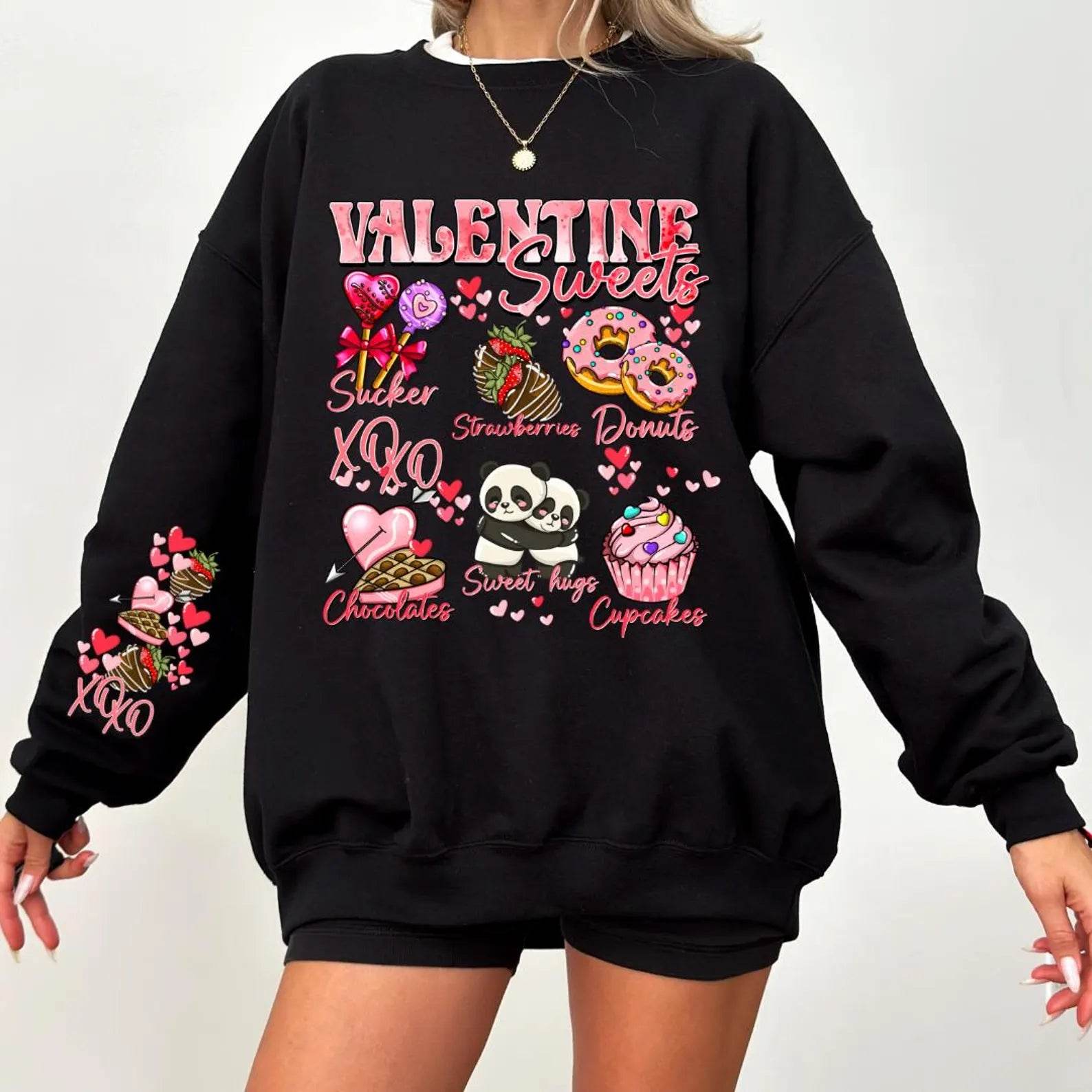 A woman  wearing a black sweatshirt with a Valentine's Day-themed graphic, surrounded by red heart-shaped balloons.valentines-sweatshirt-for-women