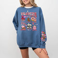 A woman sitting and smiling, wearing a blue sweatshirt with a Valentine's Day-themed graphic, surrounded by red heart-shaped balloons.valentines-sweatshirt-for-women