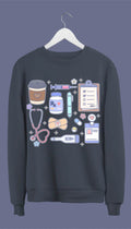 A navy blue sweatshirt with hand-drawn medical doodles including a stethoscope, syringe, band-aids, and a steaming cup of coffee.