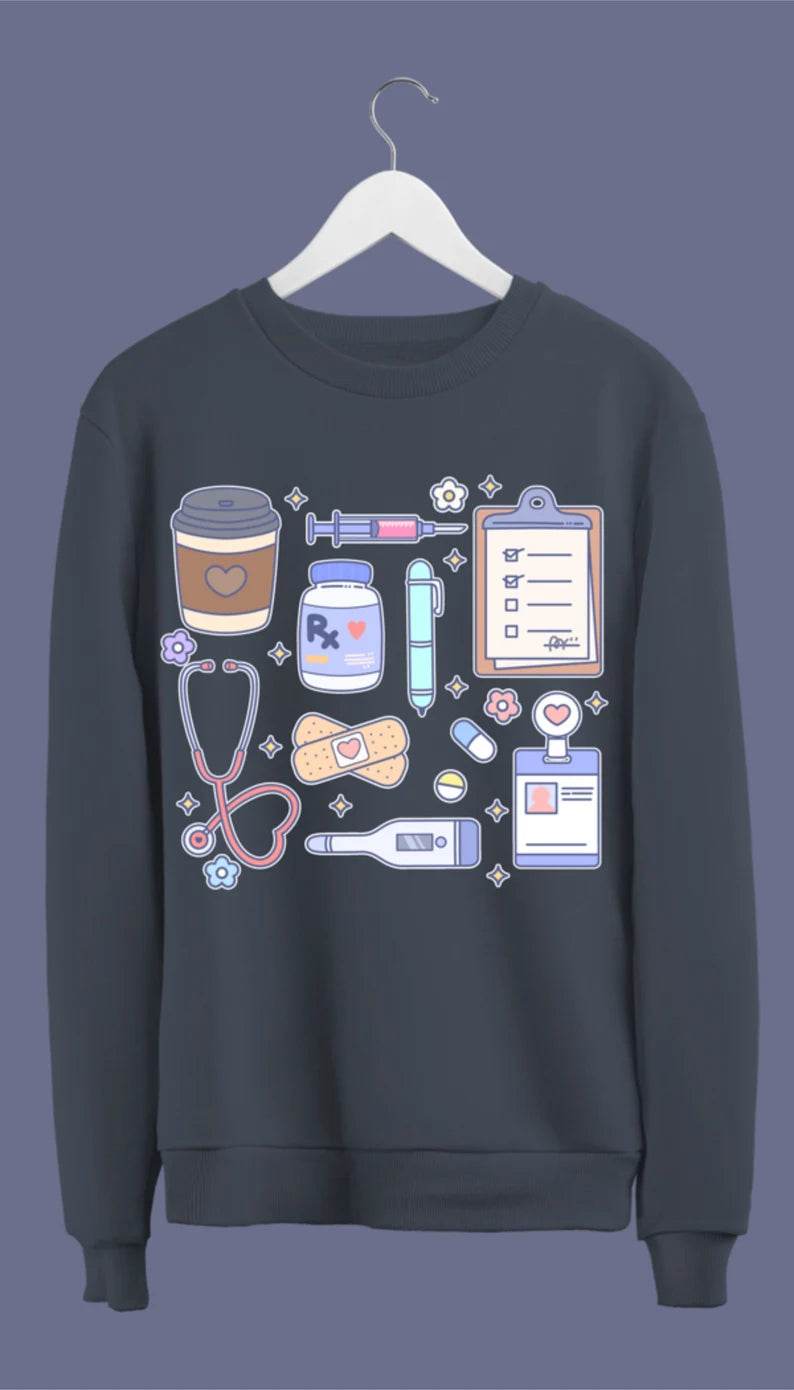 A navy blue sweatshirt with hand-drawn medical doodles including a stethoscope, syringe, band-aids, and a steaming cup of coffee.