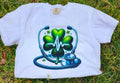 White  Heartbeat Stethoscope T-Shirt, lying on a grassy surface.