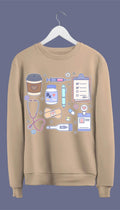 a sweatshirt with hand-drawn medical doodles including a stethoscope, syringe, band-aids, and a steaming cup of coffee.