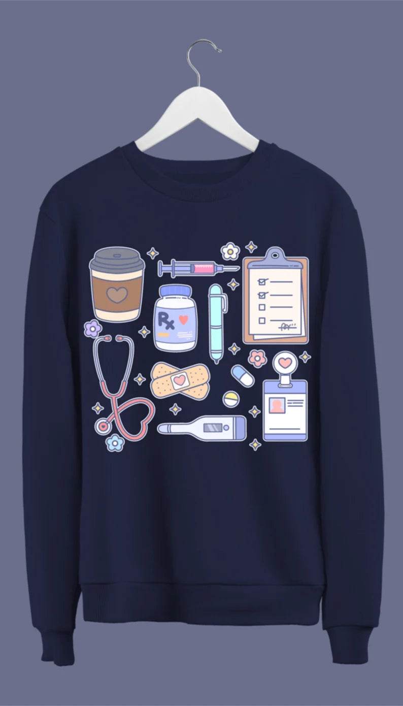 A navy blue sweatshirt with hand-drawn medical doodles including a stethoscope, syringe, band-aids, and a steaming cup of coffee.