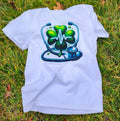 White  Heartbeat Stethoscope T-Shirt, lying on a grassy surface.